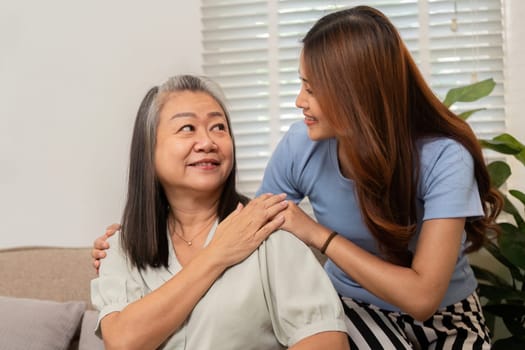 A loving interaction between a mother and daughter, where they share smiles and comfort, emphasizing their supportive relationship in a cozy setting.