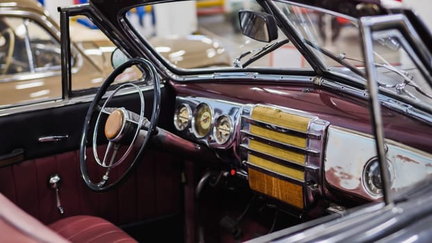 Classic convertible car interior showcasing the steering wheel, dashboard, and gauges, evoking a sense of nostalgia