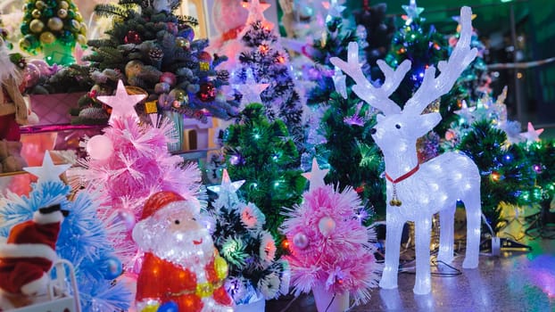 Christmas decorations shining with colorful lights, including a reindeer figure and a Santa Claus figurine