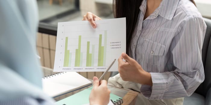 In a meeting focused on ESG strategies, the professional highlights visual data indicating progress in sustainable practices, promoting informed decisions for future actions.