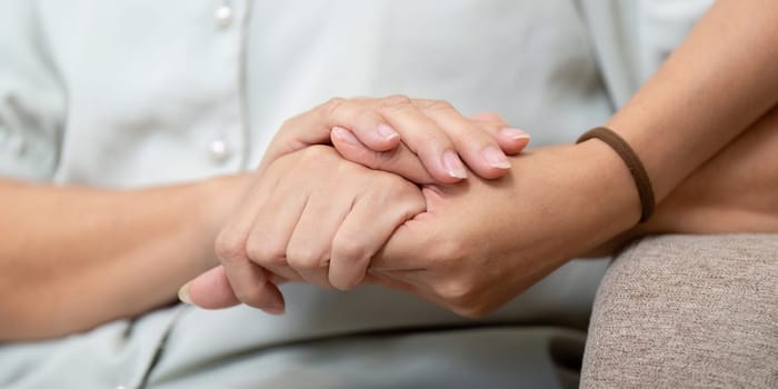 A heartfelt moment shared between a mother and daughter, symbolizing their bond through a supportive gesture as they enjoy each other's presence.