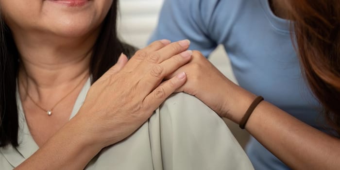 Close-up of a nurturing gesture between a mother and daughter, symbolizing their deep connection and support for each other's well-being.