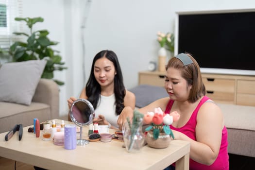 Two women engage in a self-care ritual, applying products and enjoying each other's company, reflecting their friendship and self-love.
