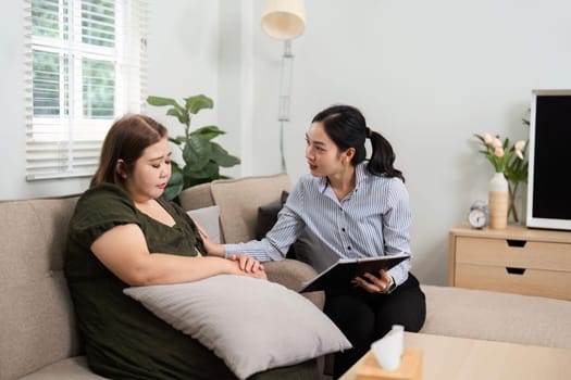 In a serene therapy setting, a psychiatrist engages with a client, facilitating her emotional exploration with empathy and understanding.