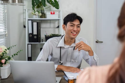 A smiling doctor discusses health concerns with a patient during a routine consultation, fostering a warm and supportive environment.