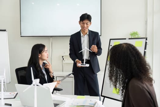 A dedicated team is engaged in a brainstorming session about sustainable practices for ESG initiatives, showcasing collaboration and innovative thinking.