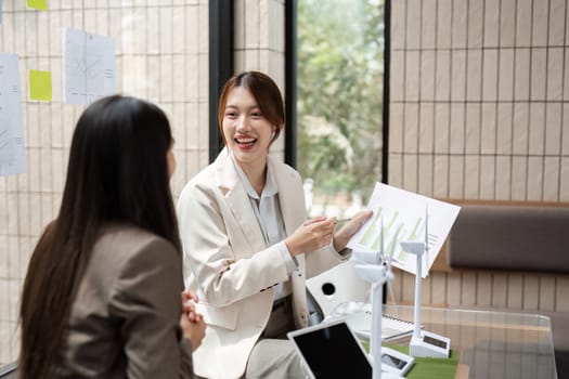 In a collaborative environment, two experts strategize on innovative solutions for promoting sustainability in business operations, with real-time feedback and ideas.