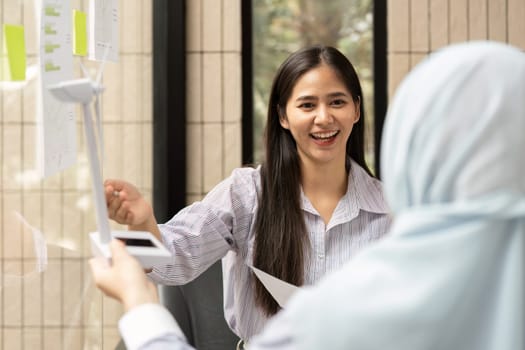 The atmosphereBuzzing with ideas, the woman emphasizes ESG strategies and sustainability measures to her partner, promoting sustainable practices.