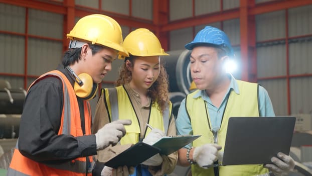 Manager leader training and assignmenting job for team of technicians worker skill quality with laptop computer at metal sheet factory, mechanical engineering team production, trainer industry factory