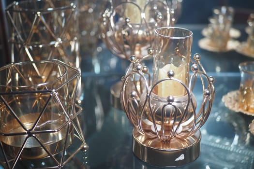 Decorative candle holders showcase intricate designs in a bright space.