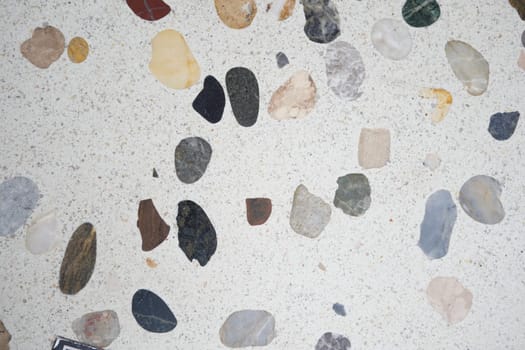 A close-up view reveals a variety of stones embedded in a smooth surface.