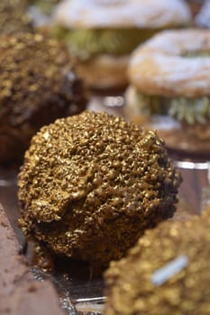 A sweet treat adorned with golden embellishments awaits at the market.