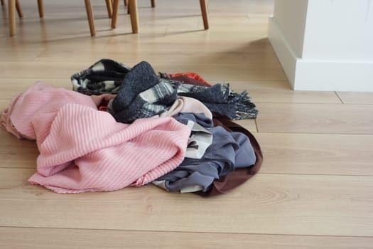 Colorful scarves are strewn on the floor, adding informal decor.