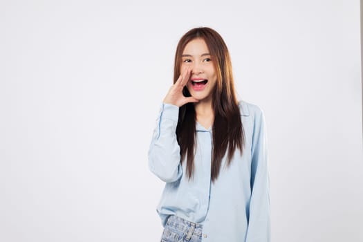 Woman shouting with joy and covering her mouth, another woman makes a news announcement with energy and enthusiasm, captured isolated on a bright white background.