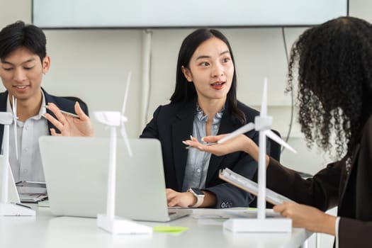 Team members engage in a lively discussion about innovative sustainable strategies, highlighting the importance of collaboration in addressing environmental challenges.