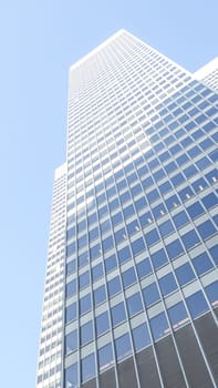 A towering glass skyscraper stands majestically against the skyline, its reflective surface mirroring the city and sky. This modern architectural marvel embodies urban sophistication and innovation.