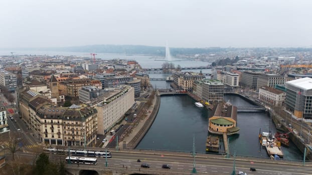 Geneve, Switzerland 04.11.2025 Drone photo of a European city with multiple river bridges, a lakeside promenade, trams on a bridge, and a central water fountain.