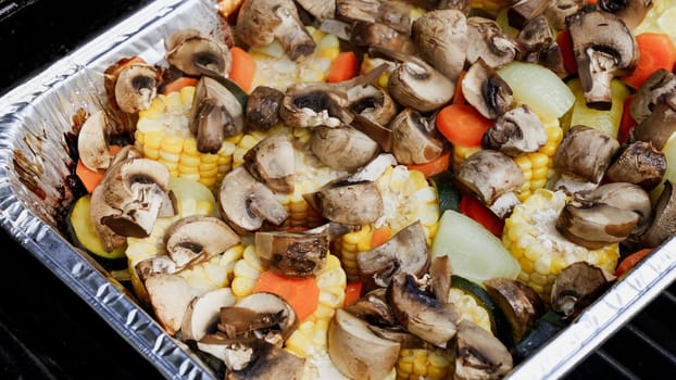 This delightful medley features grilled corn, mushrooms, carrots, zucchini, and onions, creating a nutritious and tasty side dish, perfect for summer barbecues or as a meatless main course.