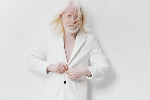 A contemporary model in a sophisticated white blazer is portrayed on a minimalist white background The model s light hair in motion enhances the artistic expression of elegance and modernity in fashion photography