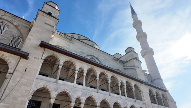 Stunning mosque architecture highlighted by sunshine and a blue sky.