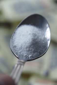 Silver spoon filled with sugar substitute , sweetener sugar.