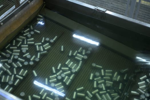 Metal cans submerged in water during the cleaning or sterilization stage in seafood factory.