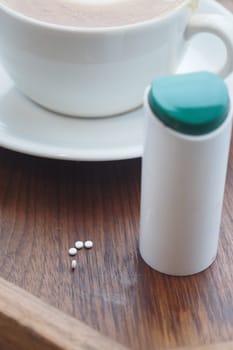 Artificial sweetener container on table,