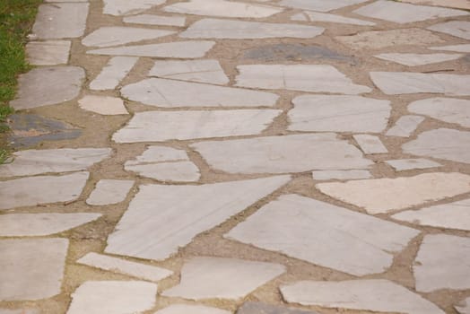 A stone path winds through lush greenery, evoking tranquility.