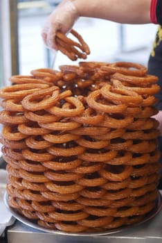 Stacked of Turkish dessert, Tulumba ready for serving in a busy market,