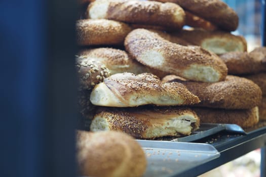 Artisan bread with sesame seeds stacked on a market stall