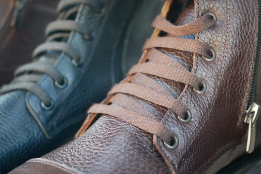 Close-up view of brown and black leather shoes with tied laces in store display.