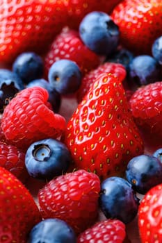 A vibrant collection of ripe strawberries and blueberries creates an inviting display.