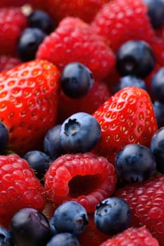 A colorful assortment of fresh strawberries and blueberries is gathered together. The juicy berries showcase vibrant reds and deep blues, inviting a refreshing taste of summer on a sunny afternoon.