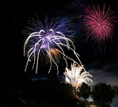 Firework display on the night sky at a festival