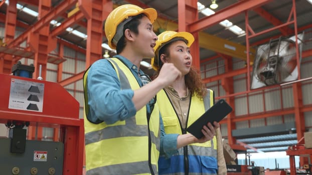 Factory manager and worker discuss something together with tablet computer, Two multiethnic metal sheet industrial workers meeting and discussing to new project plan, Quality control management