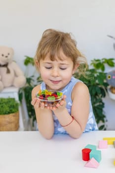 Child with jelly candies. Selective focus. kid.