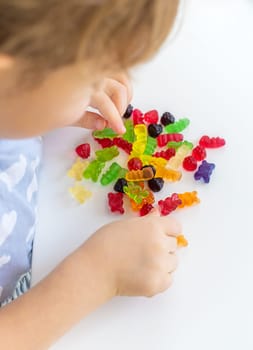 Child with jelly candies. Selective focus. kid.