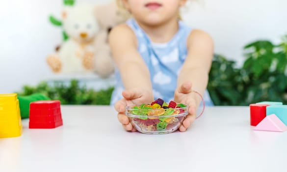 Child with jelly candies. Selective focus. kid.