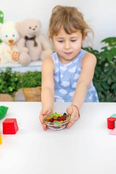 Child with jelly candies. Selective focus. kid.