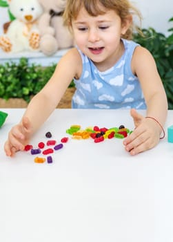 Child with jelly candies. Selective focus. kid.