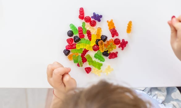 Child with jelly candies. Selective focus. kid.