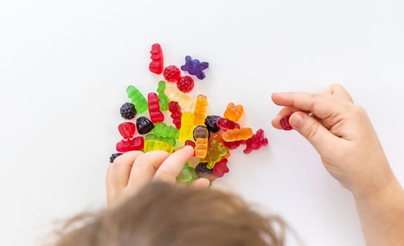 Child with jelly candies. Selective focus. kid.
