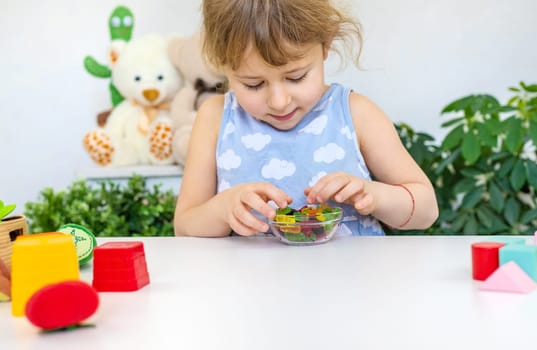 Child with jelly candies. Selective focus. kid.