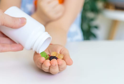 Child with jelly candies. Selective focus. kid.