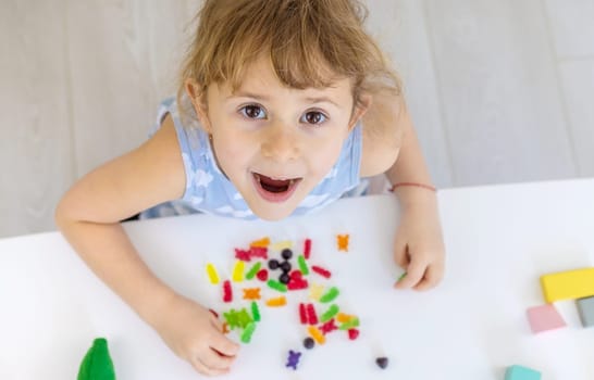 Child with jelly candies. Selective focus. kid.