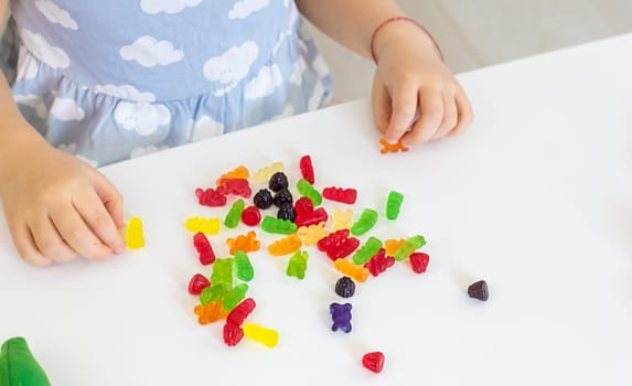 Child with jelly candies. Selective focus. kid.