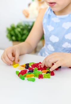 Child with jelly candies. Selective focus. kid.