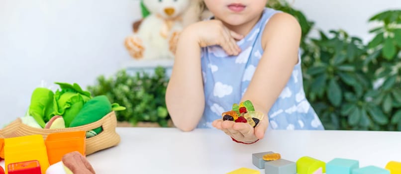 Child with jelly candies. Selective focus. kid.
