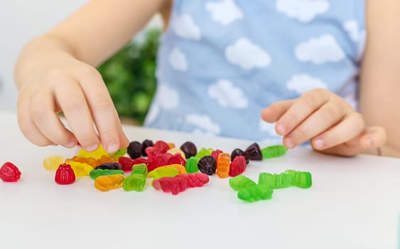 Child with jelly candies. Selective focus. kid.