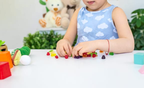 Child with jelly candies. Selective focus. kid.